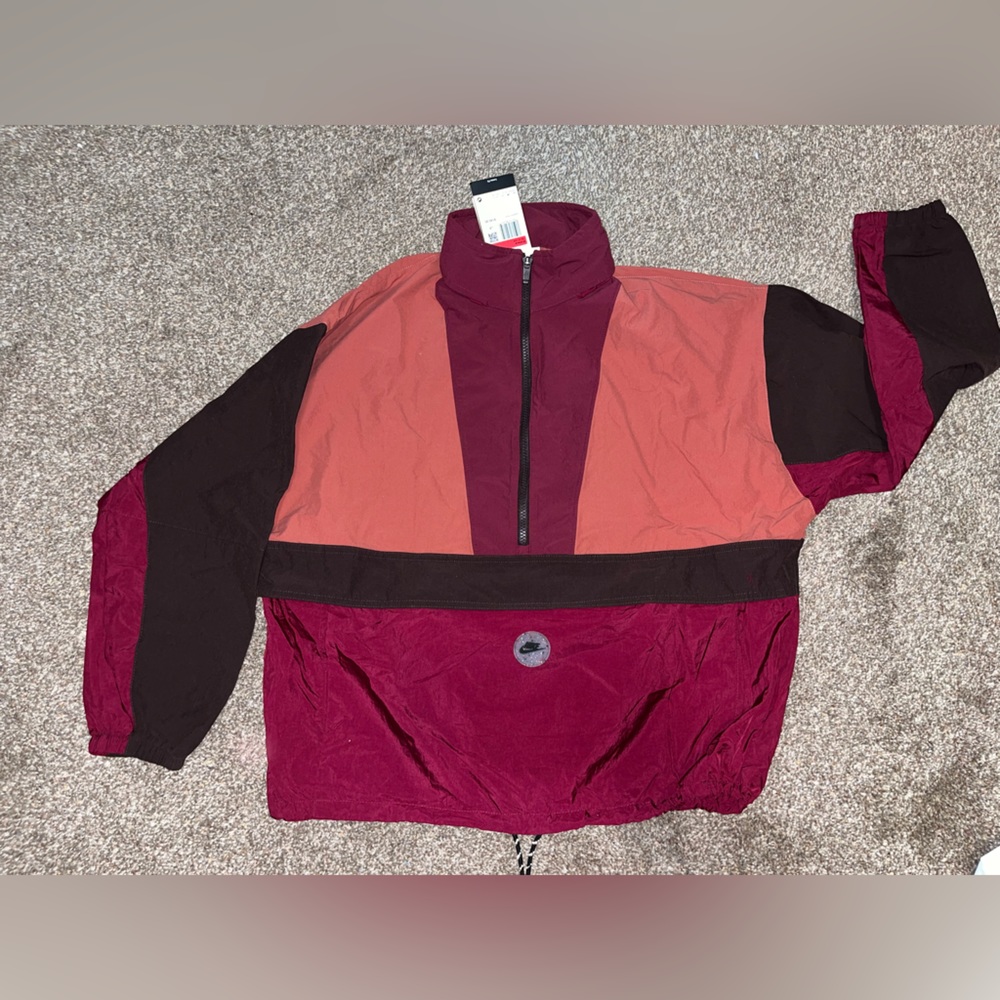Nike windbreaker pullover with hidden hood. Loose fit